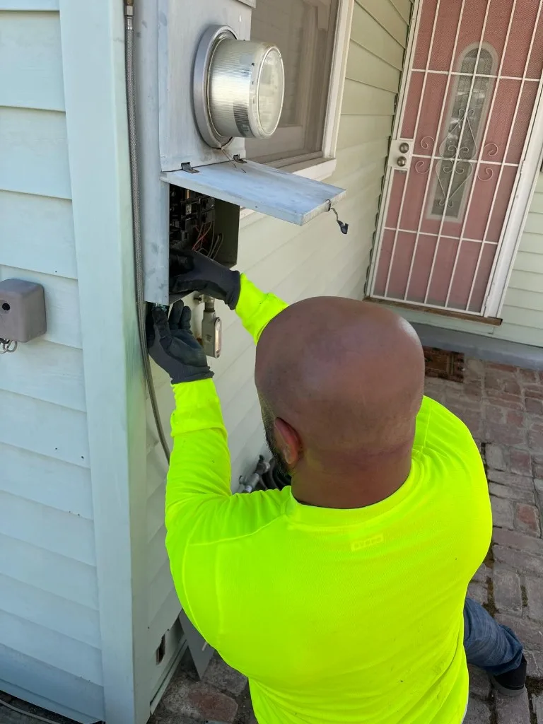 Electrician inspecting a residential meter and panel